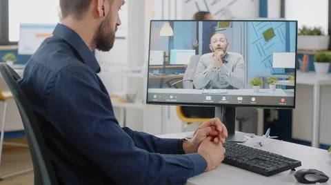 Entrepreneur using video call on computer for discussion with manager Stock Photos