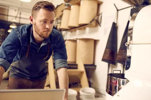 Entrepreneur working in his neat and modern coffee roastery Stock Photos