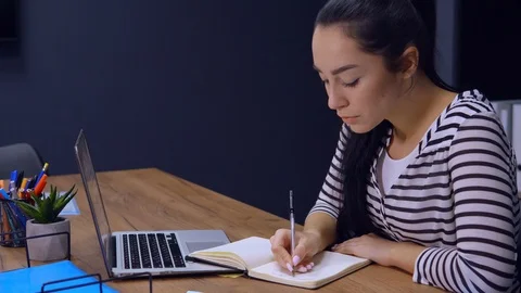 Entrepreneur writes to do list at work Stock Footage 104835391