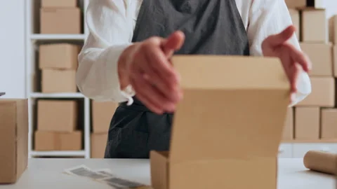 Entrepreneurial activity, Warehouse worker Confidently packs goods in a box Video stock 233813007