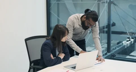 Entrepreneurial Duo Solving Work Tasks in Modern Office Stock Footage 250027404