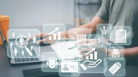 Entrepreneurs work on laptops that feature customer analytics icons, market.. Stock Photos