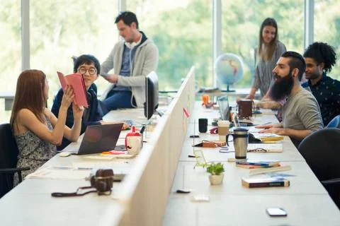 Entrepreneurs working in open plan office Stock Photos