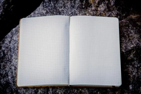 Entries in a notebook, net notebook on a granite stone Stock Photos