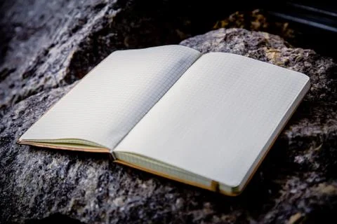 Entries in a notebook, net notebook on a granite stone Stock Photos