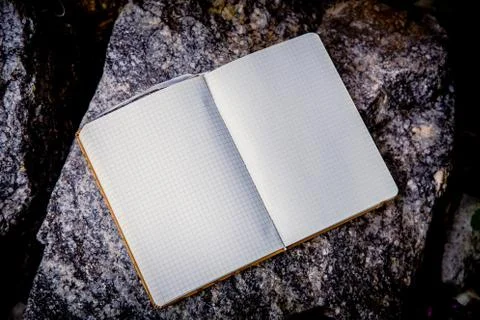 Entries in a notebook, net notebook on a granite stone Stock Photos