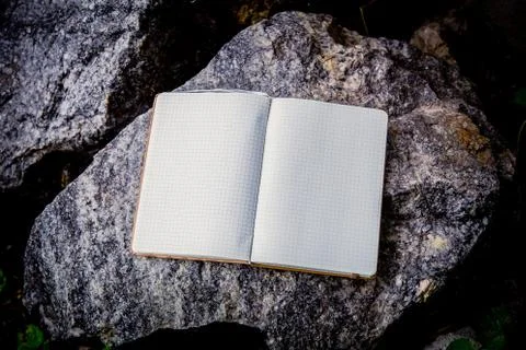 Entries in a notebook, net notebook on a granite stone Stock Photos