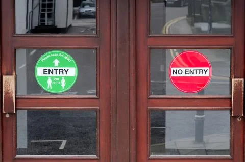 Entry and No Entry sight on shop door for customer segregation Stock Photos