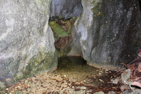 Entry to a cave in the rock Stock Photos