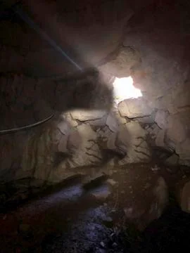 Entry to a cave in the rock Stock Photos