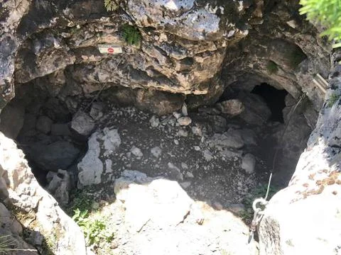 Entry to a cave in the rock Stock Photos
