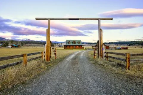 Entry gate to a nice wooden ranch home with beautiful landscape. Northwest, U Stock Photos