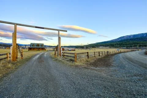 Entry gate to a nice wooden ranch home with beautiful landscape. Northwest, U Stock Photos