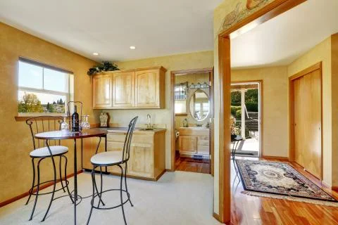 Entryway of duplex house. View of dining area with cabinets Stock Photos