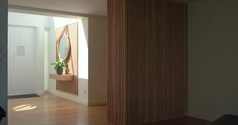 In entryway sunlight shifting through window is sliding light patch beside 스톡 동영상 336437304