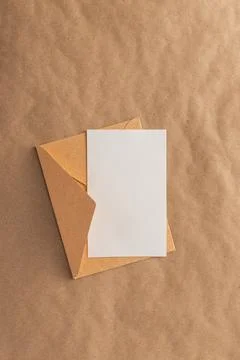 Envelope and blank card on brown kraft paper Stock Photos