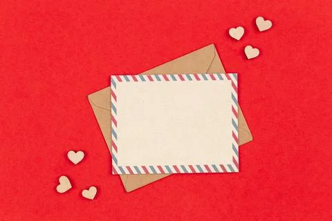 Envelope and blank postcard on a red background, Valentine's Day concept. Stock Photos