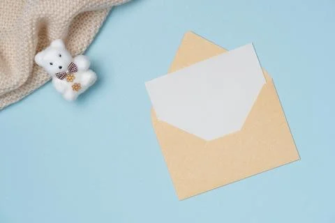 Envelope and empty white paper list with bear toy on blue background from a.. Stock Photos