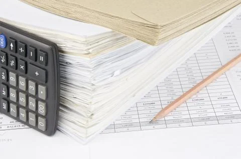 Envelope and overload of old paperwork with vertical calculator Stock Photos