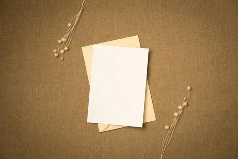 Envelope and paper blank sheet on fabric background from above. Space for tex Stock Photos