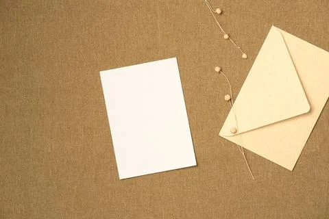 Envelope and paper blank sheet on fabric background from above. Space for tex Stock Photos