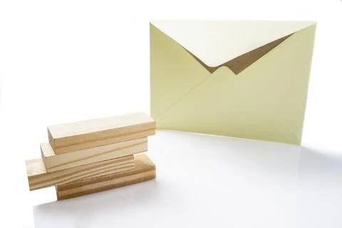 Envelope and postcard with stack of wooden blocks on white background Stockfoto's