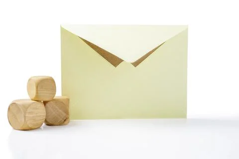 Envelope and postcard with stack of wooden cubes on white background 스톡 사진