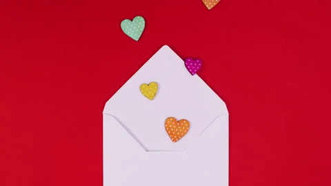 Envelope appear on red theme and hearts come out. Looping stop motion Видео 146032496