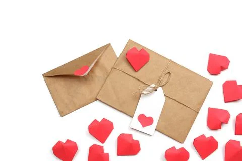 Envelope from craft paper with red heart and gift wrapped in craft paper 스톡 사진