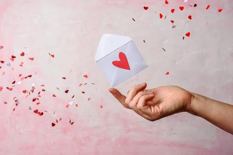 Envelope on hand with hearts Stock Photos