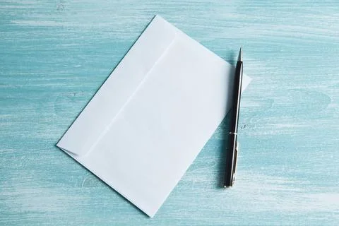 An envelope for letters and a pen on the table Stock Photos