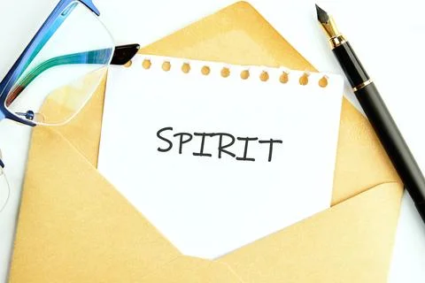 An envelope lies on a table, slightly opened to reveal a notepad with the wor 스톡 사진