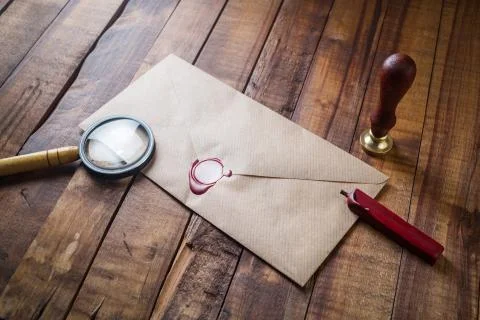 Envelope, magnifier and seal Stock Photos