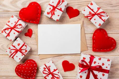 Envelope Mail with Red Heart and gift box over Orange Wooden Background. Va.. Fotos Stock