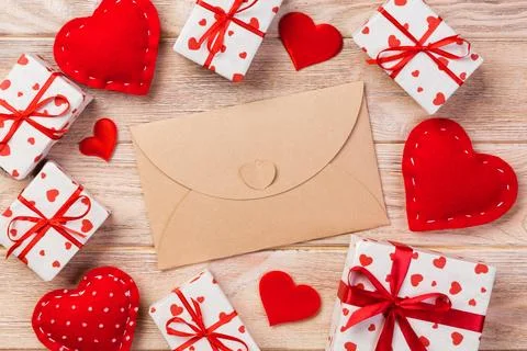 Envelope Mail with Red Heart and gift box over Orange Wooden Background. Va.. Fotos Stock