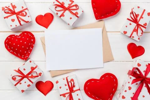 Envelope Mail with Red Heart and gift box over White Wooden Background. Val.. Fotos Stock