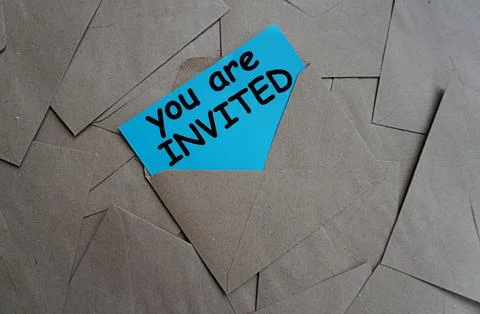Envelope with a note written you are invited, gray letter scattering background Stock Photos