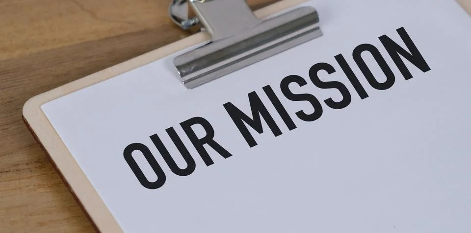 Envelope with office tools and text OUR MISSION on a white background Stock Photos