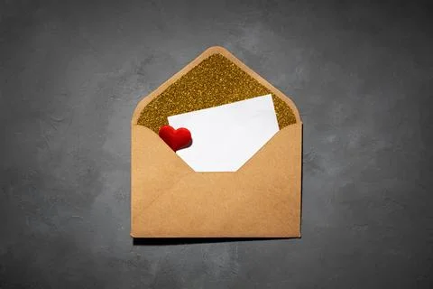 Envelope with paper inside, with copy space, on grey concrete background Stock Photos