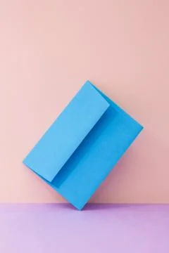 An envelope in a pink two-tone background. Stock Photos