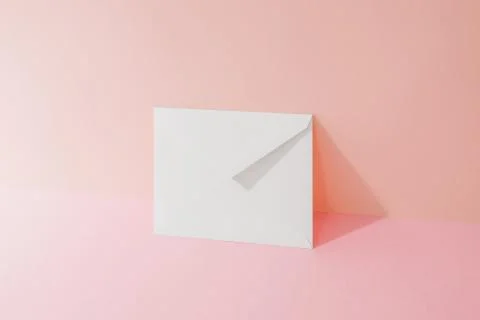 An envelope in a pink two-tone background. Stock Photos