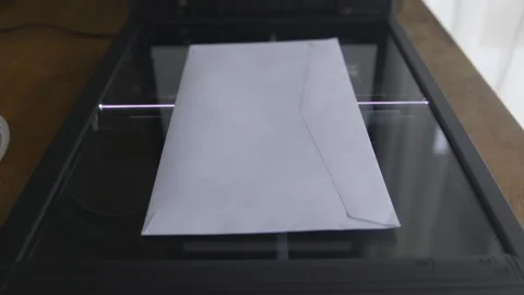 Envelope Positioned on Glass Surface of Flatbed Scanner Stock Footage 336674567