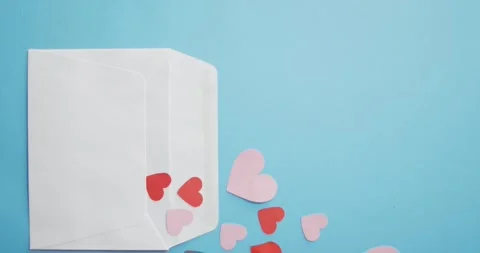Envelope with red and pink paper hearts at valentine's day on blue background Stock Footage 341735706