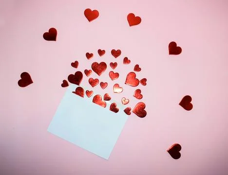 Envelope with red hearts on pink background. Valentine's day concept. Stock Photos