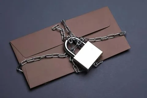 Envelope sealed with chain and lock for security or privacy Stock Photos
