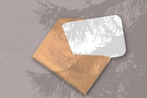 An envelope with sheet of textured white paper on the brawn background of the Stock Illustration