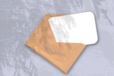 An envelope with sheet of textured white paper on the blue background of the  Stock Photos
