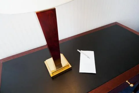 Envelope on table with electric lamp Stock Photos