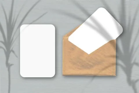 An envelope with two sheets of textured white paper on a grey table backgroun Stock Illustration