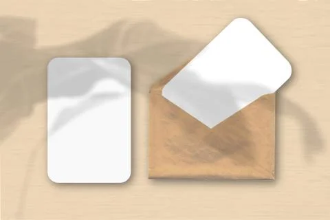 An envelope with two sheets of textured white paper on a yellow table backgro Stock Illustration